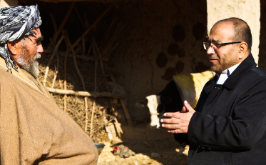 Abdul Rahim Nasry talking to Taj Mohammad in Sholgara, Afghanistan