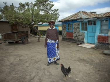 Philomena Nduku standing outside her house.
