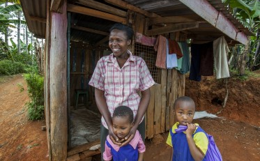 Hannah Haciku, a tailor from Nairobi, Kenya, with two children
