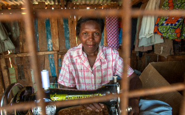 Hannah Haciku, a tailor in Nairobi, Kenya in her sewing studio