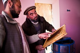 Two Afghan men discussing a craft-work. 