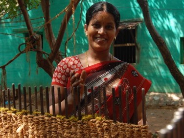 Bhanumathi, a mat maker who runs a business showing one of her mats.