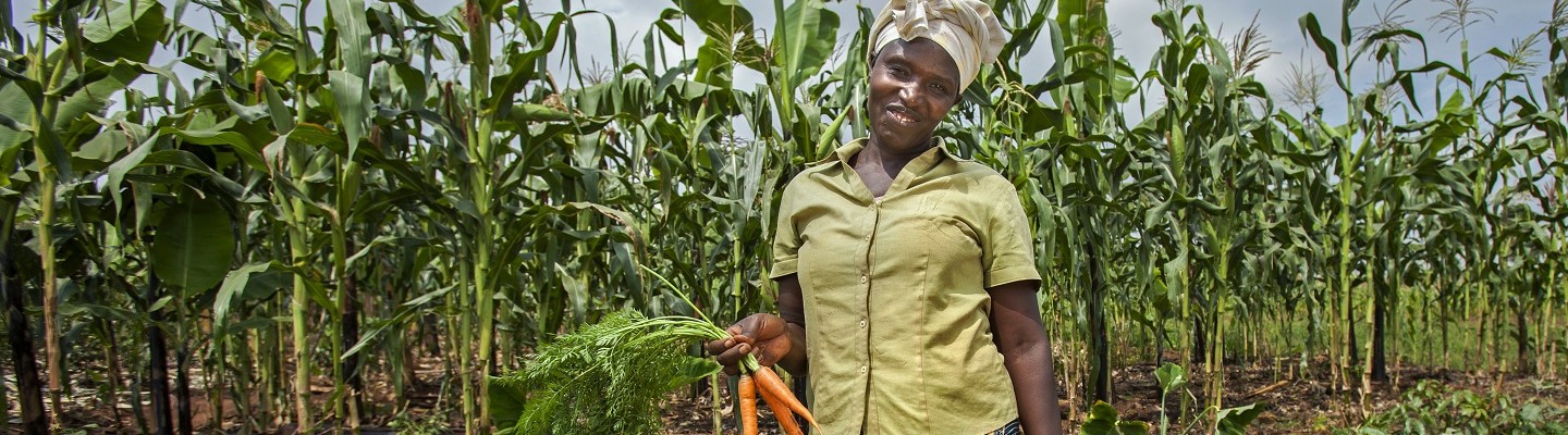 Gloria Kabagwira holding carrots | Organic produce farmer | Abaticumuga, Rwanda