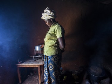 Gloria Kabagwira boiling water inside her house. 