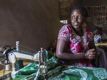 Odette Mukarusagara sitting in her sewing studio.