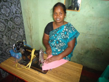 Usha sewing with a sewing machine.