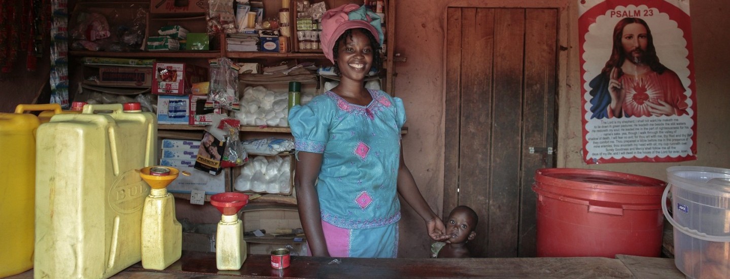 Clementine Uwimana and a child in her retail shop.