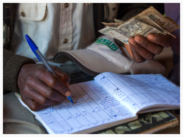 Kanyoni self-help goup treasurer counting money | Thika outskirts, Kenya